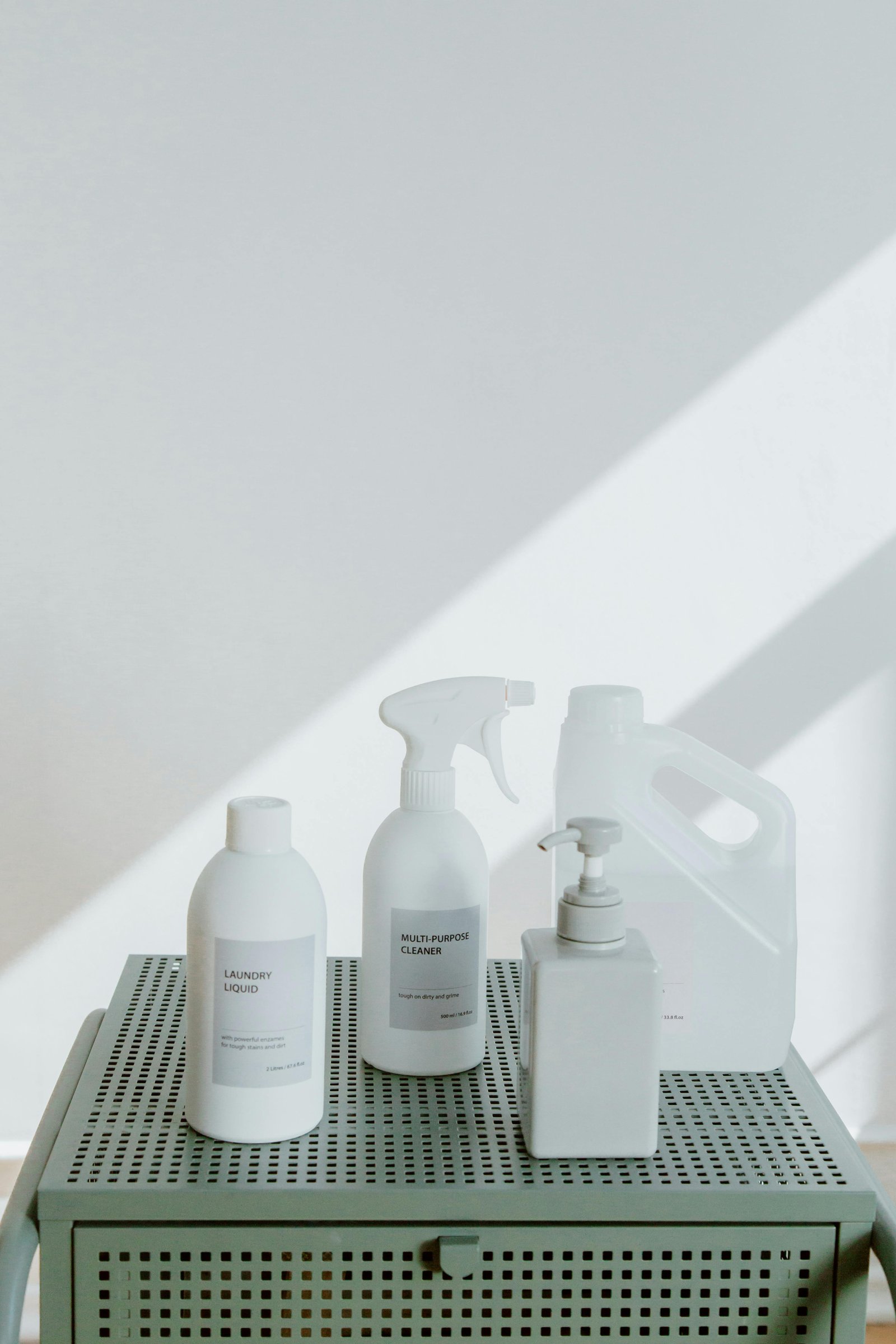 Minimal household cleaning products arranged neatly in soft daylight